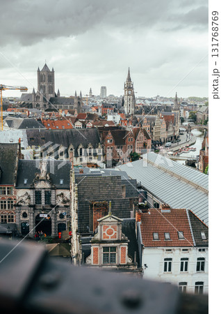 Wide cityscape from Gravensteen Castle featuring the rooftops, churches, and canals of Ghent. 131768769