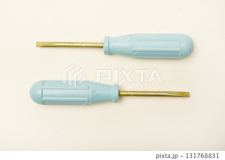 A light blue phillips screwdriver on a white background. A hand tool. 131768831