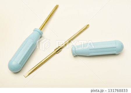 A light blue phillips screwdriver on a white background. A hand tool. 131768833