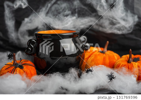 Halloween Cauldron with Pumpkins, Spiders and Cobwebs 131769396
