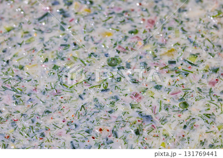 Creamy vegetable okroska soup with herbs in indoor close-up view Creamy vegetable okroska soup with herbs in indoor close-up view 131769441