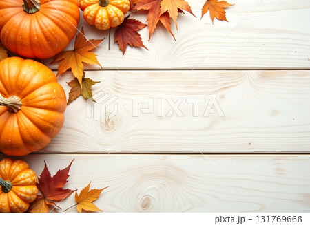 Pumpkin motif with autumn foliage on a wooden background 131769668
