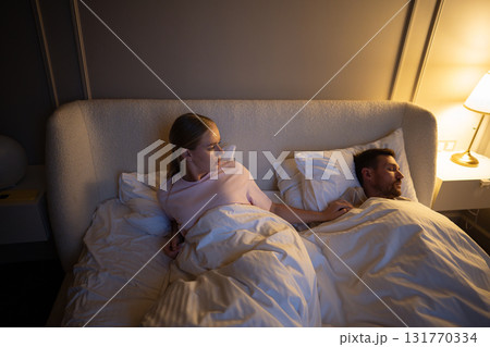 Exhausted wife unable to sleep at night from partner loud snore in room. Sleep disruption fatigue Exhausted wife unable to sleep at night from partner loud snore in room. Sleep disruption fatigue 131770334
