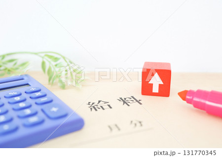 給料袋と上向き矢印で示す賃上げや昇給の概念。 131770345