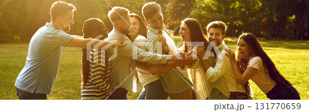 Group of happy cheerful diverse friends meeting and hugging in sunny summer park Group of happy cheerful diverse friends meeting and hugging in sunny summer park 131770659
