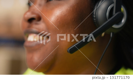 Call center clerk parcel tracking and order dispatch on help line, working in an online shopping logistics center. Worker resolving cargo issues and packages lost in distribution process. Camera B. Call center clerk parcel tracking and order dispatch on help line, working in an online shopping logistics center. Worker resolving cargo issues and packages lost in distribution process. Camera B. 131771170