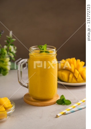 Mango smoothie in a glass with fresh fruit and mint 131772723