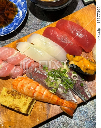 An assortment of fresh sushi, artfully arranged with a variety of toppings and vibrant colors. This traditional Japanese dish combines vinegared rice, seafood, and vegetables for an experience. 131773994