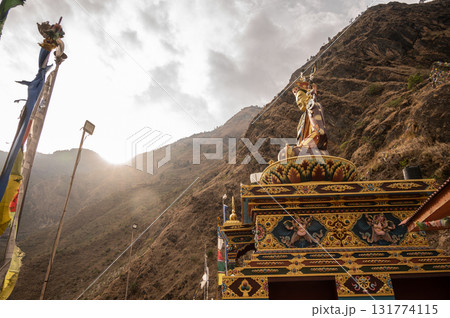 Statue of Guru Rinpoche on the small hill in Syabrubesi a beautiful resident village inside the Langtang National Park of Nepal. Statue of Guru Rinpoche on the small hill in Syabrubesi a beautiful resident village inside the Langtang National Park of Nepal. 131774115