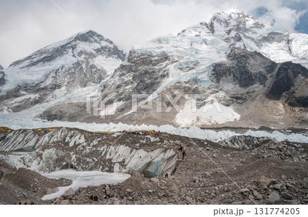 Tourist walking on Khumbu glacier to Everest base camp, Nepal. The Everest Base Camp (EBC) trek is a spectacular high altitude trek in the mountains of Nepal. 131774205