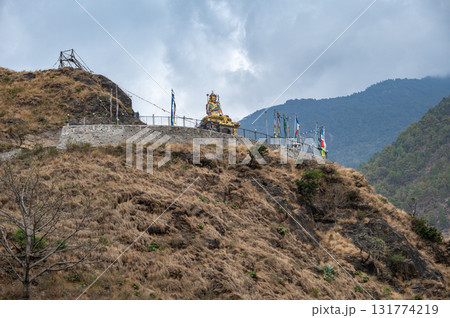 Statue of Guru Rinpoche on the small hill in Syabrubesi a beautiful resident village inside the Langtang National Park of Nepal. 131774219