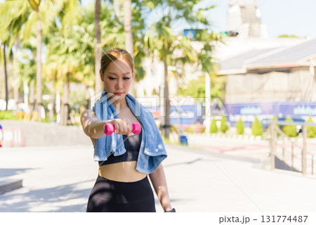 Fit woman sport exercise workout outdoor, people maintaining active lifestyle, lifting pink dumbbell, strengthening body, achieving fit physique, tropical setting. Fit woman sport exercise workout outdoor, people maintaining active lifestyle, lifting pink dumbbell, strengthening body, achieving fit physique, tropical setting. 131774487