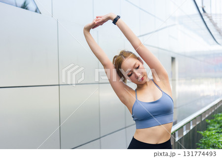 Sport woman, fit athlete, performs invigorating outdoor exercise workout, stretching body for health, showing commitment to active lifestyle and her sport, inspiring people to fitness. Sport woman, fit athlete, performs invigorating outdoor exercise workout, stretching body for health, showing commitment to active lifestyle and her sport, inspiring people to fitness. 131774493