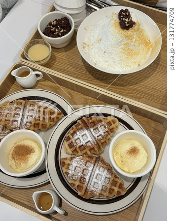 Crispy, golden waffles topped with creamy ice cream, creating a perfect balance of warm and cold, crunchy and smooth. A delightful dessert or breakfast treat, with toppings like fruits or syrup. Crispy, golden waffles topped with creamy ice cream, creating a perfect balance of warm and cold, crunchy and smooth. A delightful dessert or breakfast treat, with toppings like fruits or syrup. 131774709