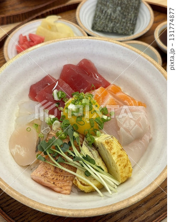 Fresh and delicate sashimi slices, beautifully presented with vibrant colors and perfect cuts. This traditional Japanese delicacy highlights the pure flavors of premium seafood. 131774877