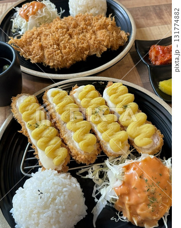 Crispy tonkatsu cutlet stuffed with melted cheese, creating a savory blend of crunch and creaminess. A comforting and satisfying dish with a rich, golden finish. Crispy tonkatsu cutlet stuffed with melted cheese, creating a savory blend of crunch and creaminess. A comforting and satisfying dish with a rich, golden finish. 131774882