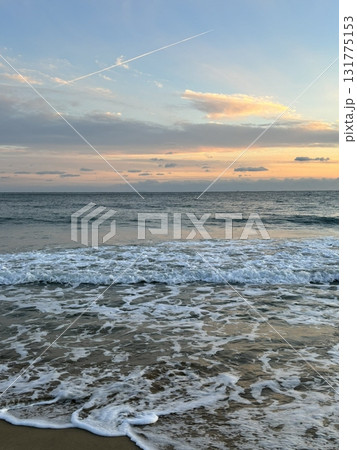 A stunning beach sunset, with vibrant hues of orange, pink, and purple reflecting on the water. Perfect for travel photography, capturing the beauty and tranquility of coastal evening A stunning beach sunset, with vibrant hues of orange, pink, and purple reflecting on the water. Perfect for travel photography, capturing the beauty and tranquility of coastal evening 131775153