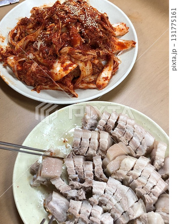 Suyuk, a traditional Korean dish of boiled pork slices, tender and juicy, often served with salted shrimp sauce, garlic, and ssamjang. Perfect for wrapping in lettuce for a flavorful, balanced bite. Suyuk, a traditional Korean dish of boiled pork slices, tender and juicy, often served with salted shrimp sauce, garlic, and ssamjang. Perfect for wrapping in lettuce for a flavorful, balanced bite. 131775161
