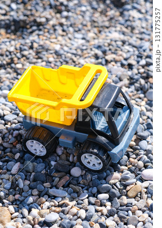 A toy truck is sitting on a pile of rocks 131775257