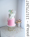 A pink and white wedding cake with a green leaf on top and the words "Mr 131775267