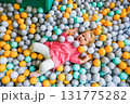 Girl playing in the pool with colored balloons in the children's center 131775282