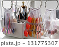 A nail polish color chart hangs on a white shelf  131775307
