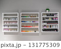 A wall of shelves with many bottles of nail polish 131775309