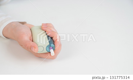 Woman holding electronic cigarette on white background. Tobacco heating systems. Woman holding electronic cigarette on white background. Tobacco heating systems. 131775314