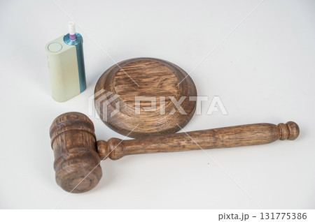Judge's gavel and e-cigarette. Smoking ban. Tobacco heating systems. Judge's gavel and e-cigarette. Smoking ban. Tobacco heating systems. 131775386