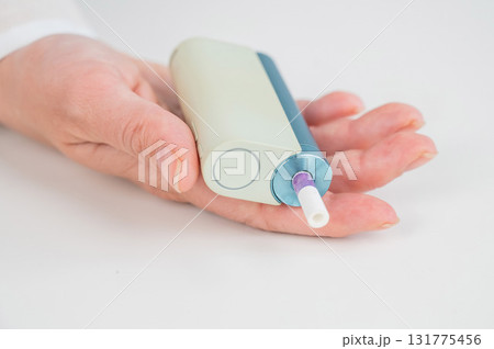 Woman holding electronic cigarette on white background. Tobacco heating systems. 131775456