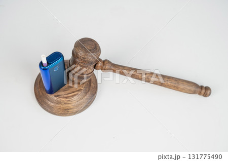 Judge's gavel and e-cigarette. Smoking ban. Tobacco heating systems.  131775490