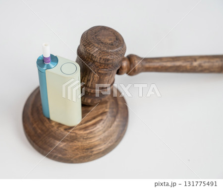 Judge's gavel and e-cigarette. Smoking ban. Tobacco heating systems. Judge's gavel and e-cigarette. Smoking ban. Tobacco heating systems. 131775491