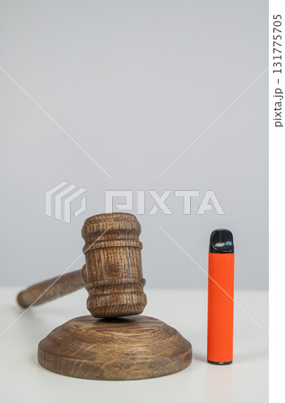 Judge's gavel hits disposable vape. Smoking ban. Judge's gavel hits disposable vape. Smoking ban. 131775705