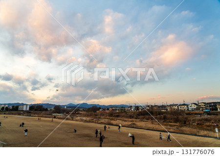 夕方の凧揚げを楽しむ家族 131776076