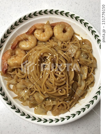 Creamy and rich spaghetti coated in a luscious white sauce, offering a smooth and savory flavor perfect for a comforting and satisfying meal. 131776150