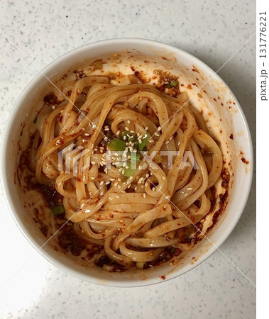 Spicy and tangy bibim guksu with chewy noodles, fresh veggies, and gochujang sauce. A vibrant and refreshing Korean cold noodle dish perfect for a light yet flavorful meal. 131776221