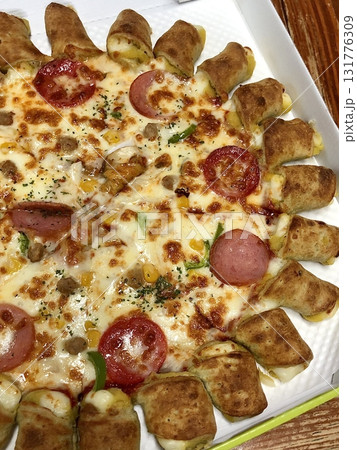 A delicious pizza with a golden crust, melted cheese, and savory toppings. Perfect for food-related designs, menus, or Italian-themed projects, capturing the essence of a classic comfort dish. 131776309