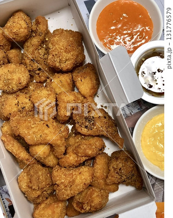 Crispy Korean fried chicken, perfectly glazed with a sweet and spicy sauce. Ideal for food photography and menus, showcasing the irresistible crunch and flavor of this beloved dish. 131776579