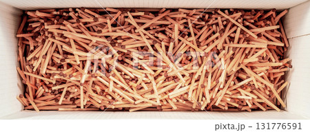 Box Full of Wooden Matches Organized in a Patterned Arrangement 131776591
