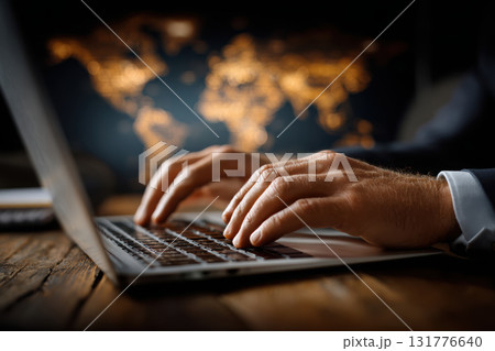 Economist analyzes international trade data with laptop 131776640