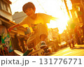 Teenage boy skateboarding with focus on a sunny street in lively afternoon light 131776771