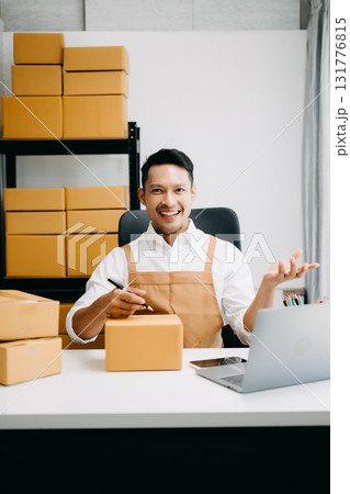 Young man running online store Startup small business SME, using smartphone or tablet taking receive and checking online purchase shopping order 131776815