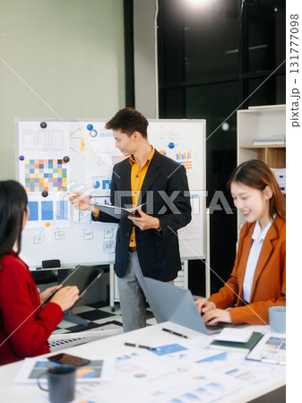 Office colleagues have a casual discussion. During a meeting in a conference room, a group of business teem Office colleagues have a casual discussion. During a meeting in a conference room, a group of business teem 131777098