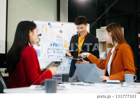 Office colleagues have a casual discussion. During a meeting in a conference room, a group of business teem Office colleagues have a casual discussion. During a meeting in a conference room, a group of business teem 131777101
