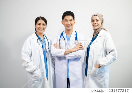 Successful team of medical doctors looking at camera and smiling while standin. Health, professional and people team Successful team of medical doctors looking at camera and smiling while standin. Health, professional and people team 131777217