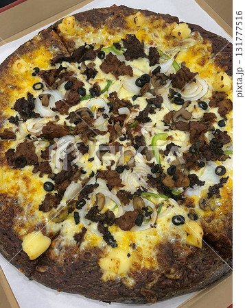 A delicious pizza with a golden crust, melted cheese, and savory toppings. Perfect for food-related designs, menus, or Italian-themed projects, capturing the essence of a classic comfort dish. 131777516