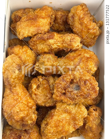 Crispy Korean fried chicken, perfectly glazed with a sweet and spicy sauce. Ideal for food photography and menus, showcasing the irresistible crunch and flavor of this beloved dish. 131777522