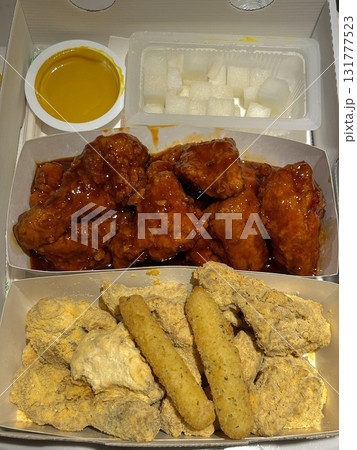 Crispy Korean fried chicken, perfectly glazed with a sweet and spicy sauce. Ideal for food photography and menus, showcasing the irresistible crunch and flavor of this beloved dish. 131777523