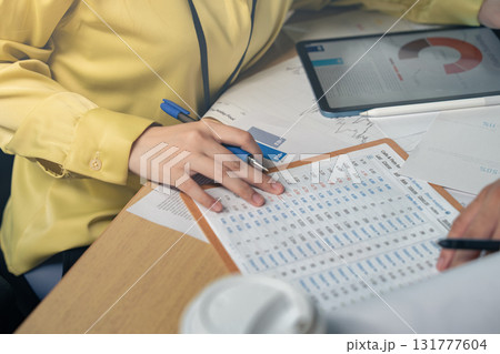 Business people, hands-on work, and people with documents in the office for data analysis, company reports, or performance reviews. Financial analysts, teams, and documents for financial forecasting,  131777604