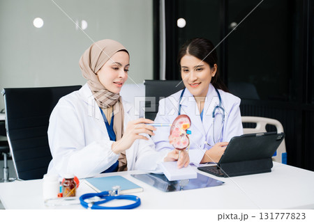 Doctors analyzing results or diagnosis of patient in clinic. Teamwork, medical and healthcare workers in discussion and research on desk in hospital 131777823